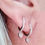 Thumbnail: Silver and baby pink heart charm huggie hoop