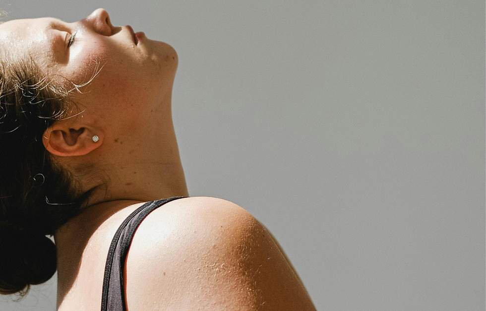 Person leaning back with eyes closed during a gentle movement practice