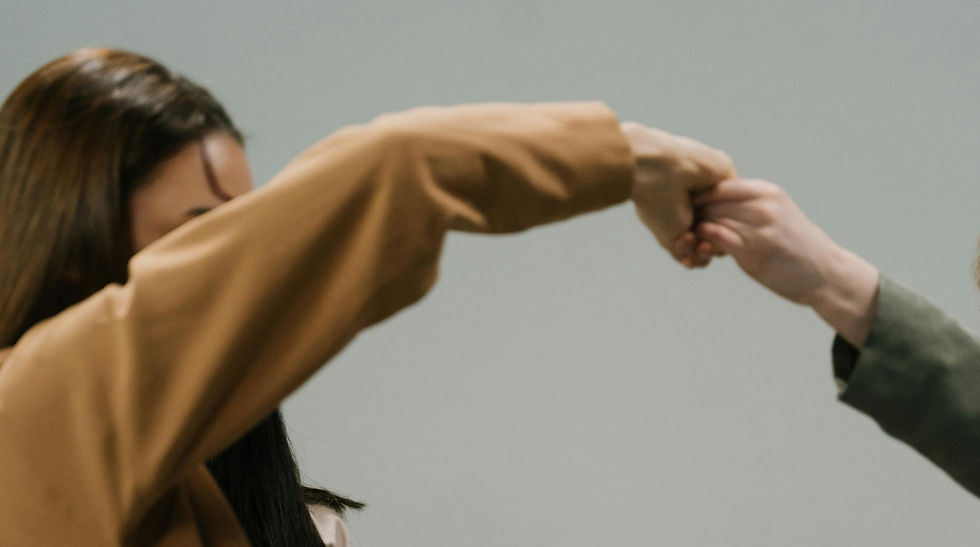 Two people connecting through gentle movement in a dance and movement therapy session