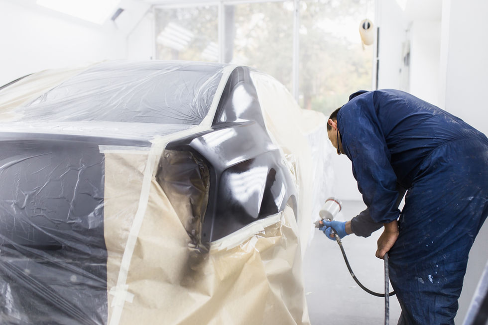 man-with-protective-clothes-mask-painting-car-using-spray-compressor-selective-focus.jpg