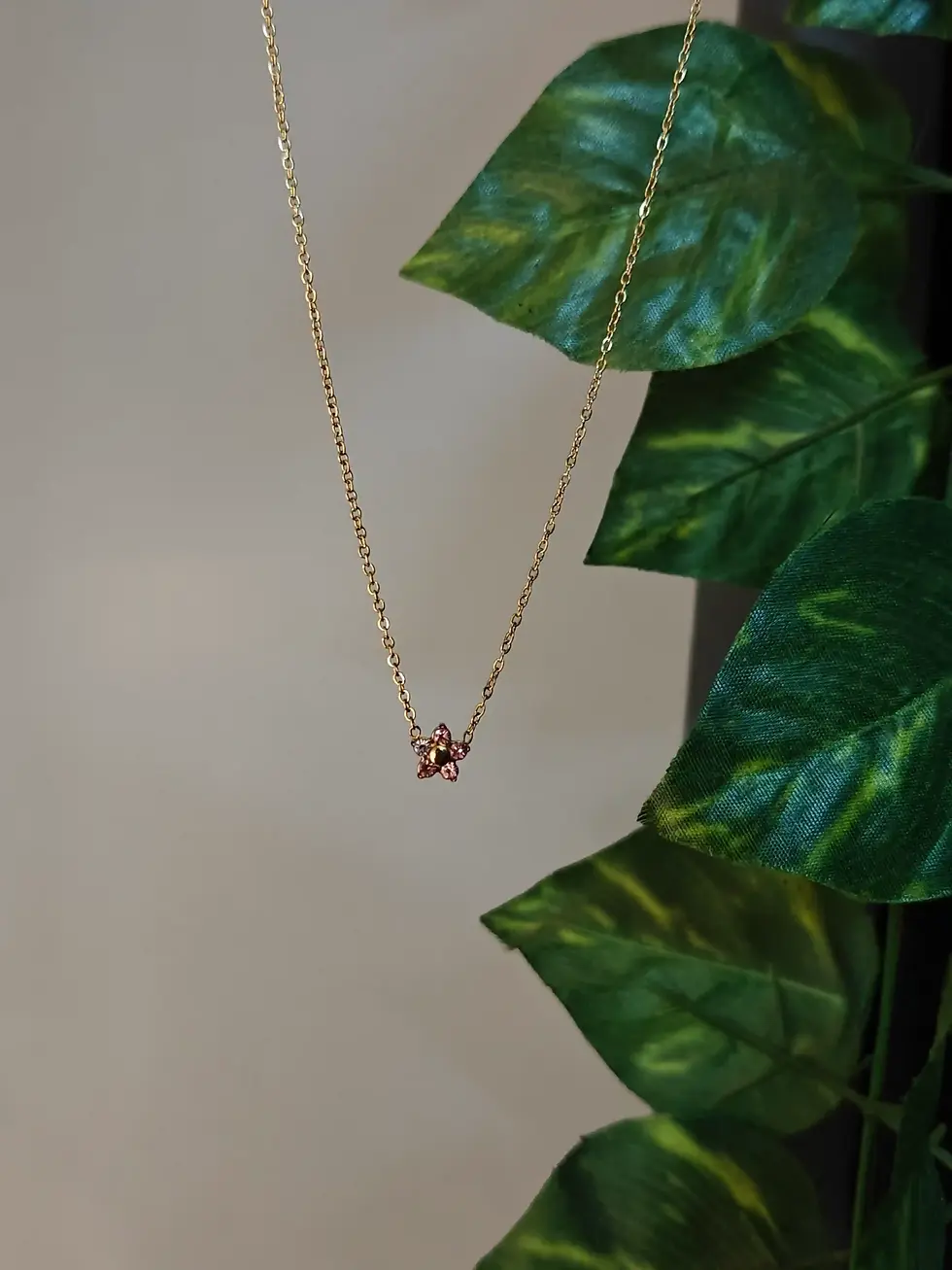 Ultra-thin chain necklace with a tiny baby pink floral stone pendant, dainty and minimal.