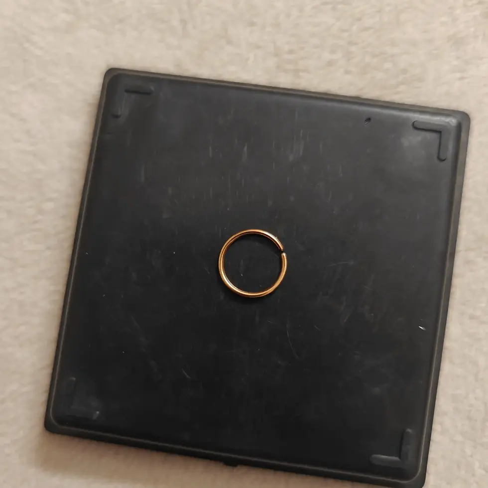 Rose gold-tone 8mm non-piercing ear ring with a minimalist circular design for stylish everyday wear.