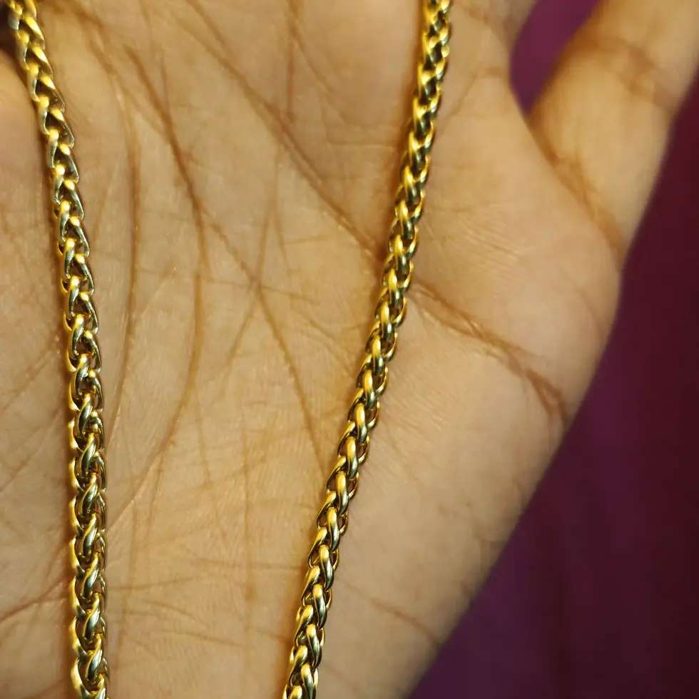 Gold-tone unisex twisted rope chain necklace with a polished finish and 56 cm medium-length fit.