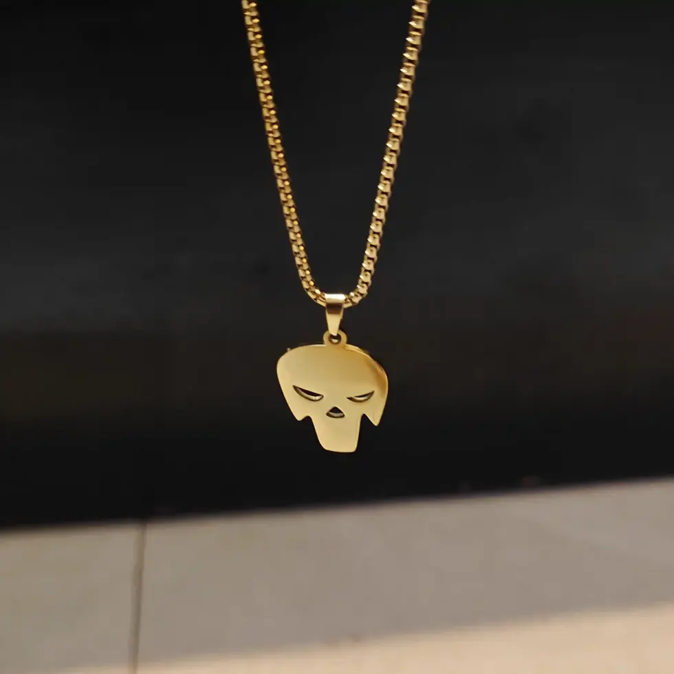 Long gold-tone men's skull pendant necklace featuring a sleek minimalist skull design on a matching chain.