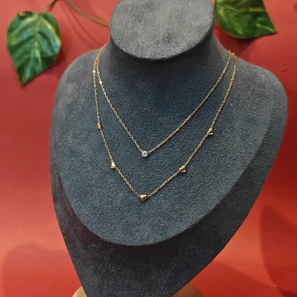 Gold-toned double-layer necklace with small crystal accents spaced along both chains.