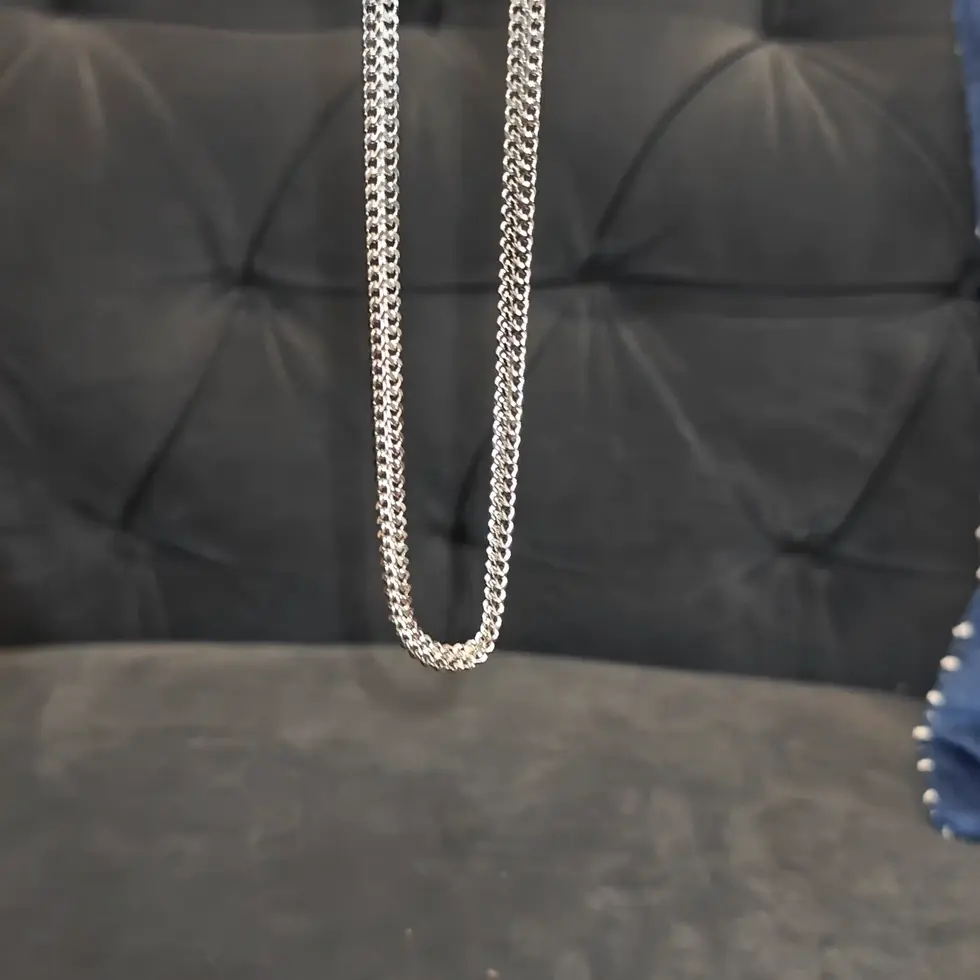 Long silver-tone men's curb chain with a bold flat-link design, perfect for making a clean everyday statement.