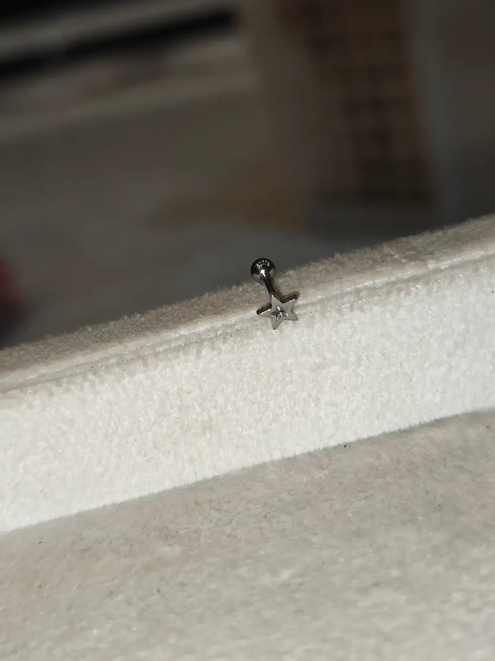 Silver-tone star-shaped stud earring with a minimalist design, perfect for everyday wear.