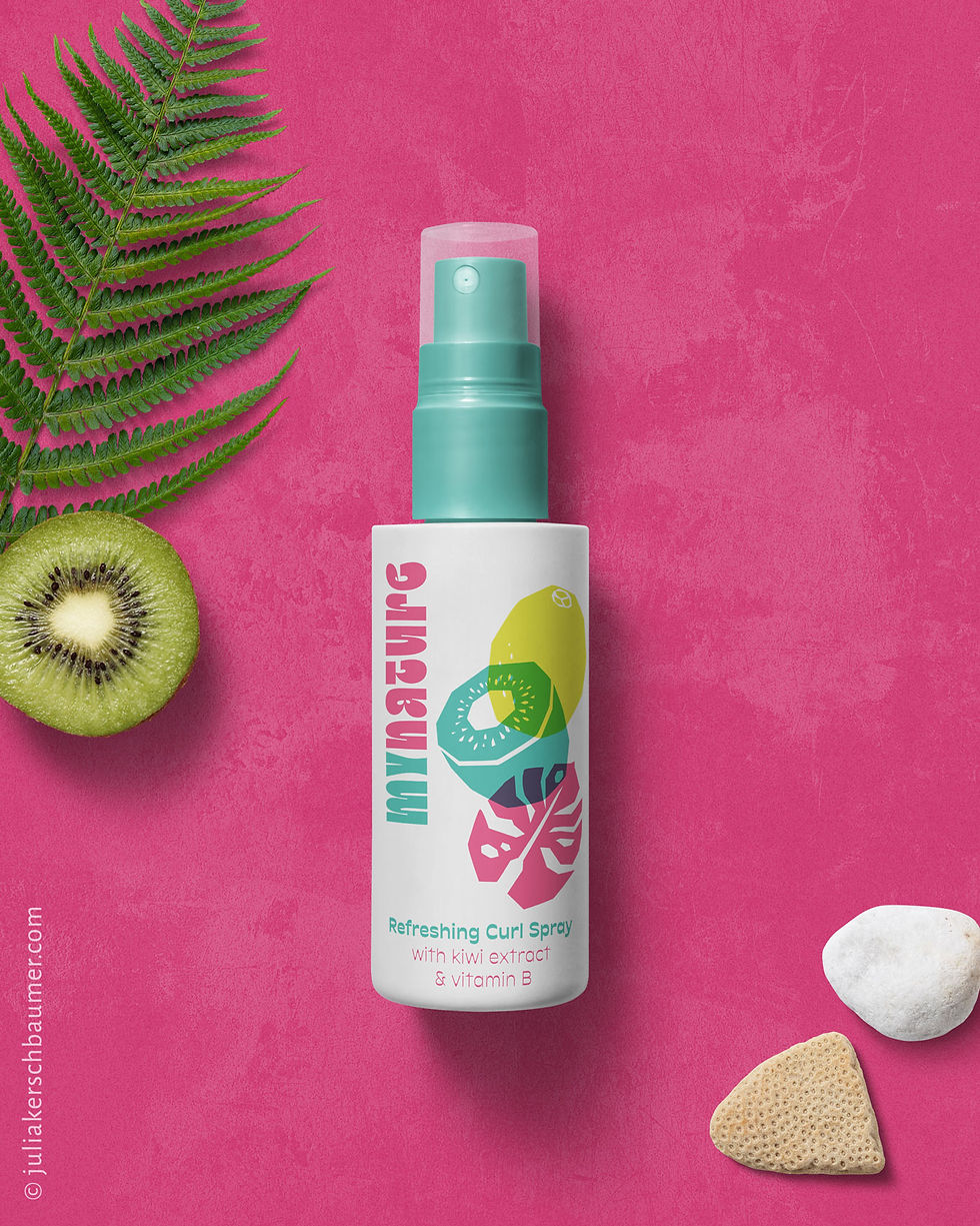 cosmetic packaging for curl spray with tropical fruit design in white, blue, pink and yellow on a pink background
