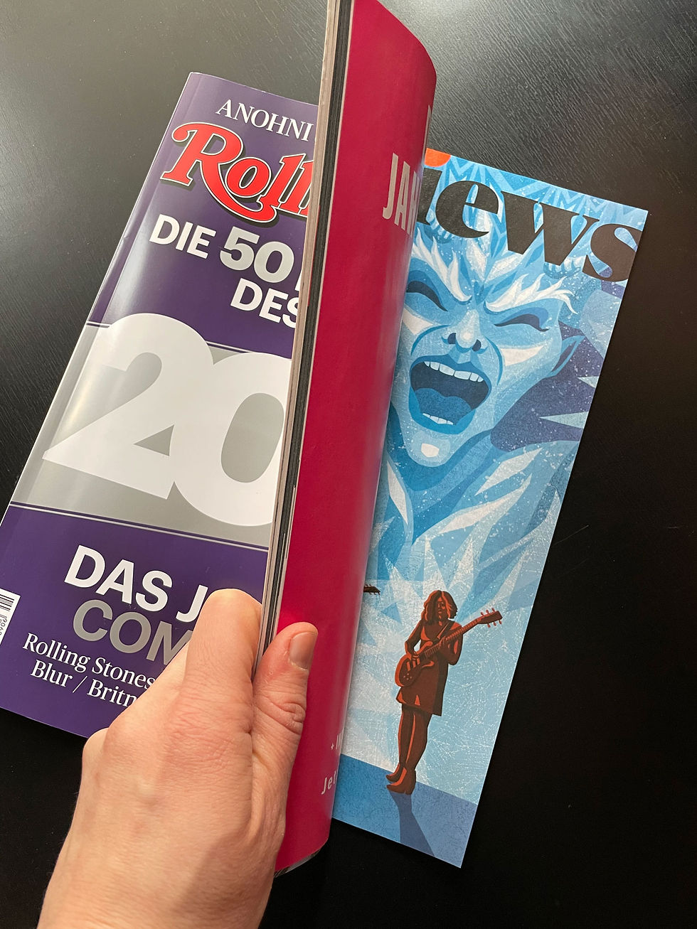 Rolling Stone Magazine photo opening on the page with a review of indie rock band Sleater-Kinney's new album, depicting the band and a screaming ice devil, illustrated by Julia Kerschbaumer