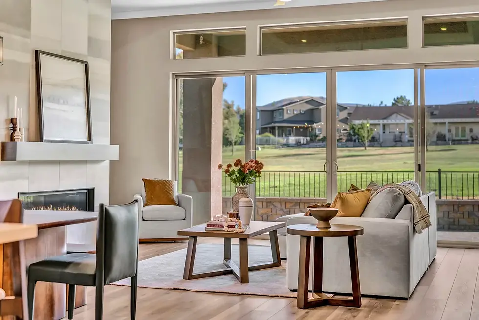 Wide-angle view of a cozy staged living room with warm lighting.