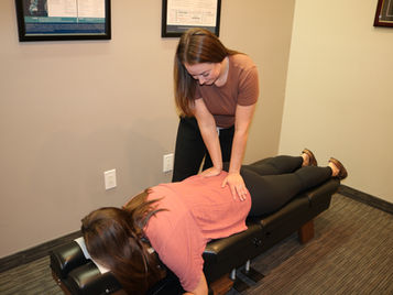 Webster-certified prenatal chiropractic adjustment for an expecting mother at Roots Chiropractic in Mesa, AZ