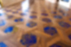 A closeup of a wooden and composite flooring in blue with yellow details 