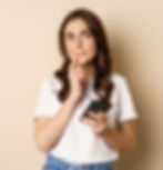 girl-thinks-holds-mobile-phone-looks-up-thoughtful-stands-beige-background_edited.jpg