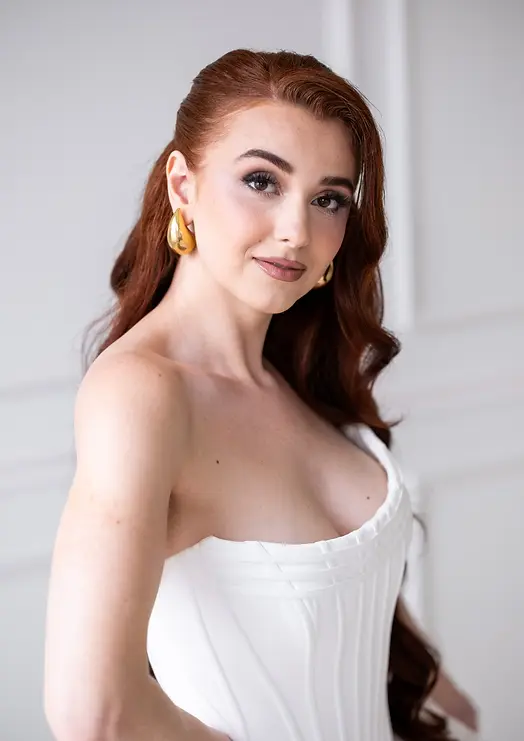 Modern bridal makeup for red-haired bride — clean skin, defined eyes, and timeless elegance.