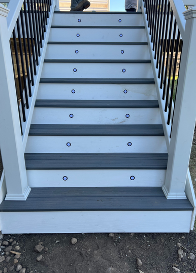 Side view of elevated Trex composite deck with stair access in South Elgin, Illinois, highlighting premium railing, fascia, and clean craftsmanship.