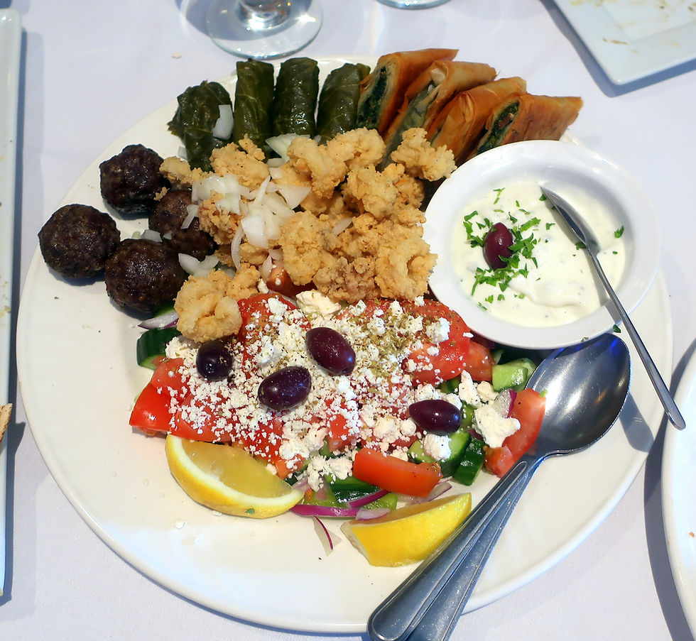 Greek salad, dolmades, meatballs, spanakopita, and kalamari.
