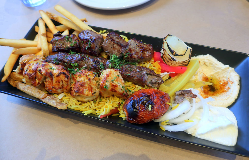Grilled skewers of BBQ beef, shish tawouk and kafta, served with fire-roasted tomato and onion, spicy pita bread, garlic potatoes, a side of smooth velvety hummus and garlic sauce.