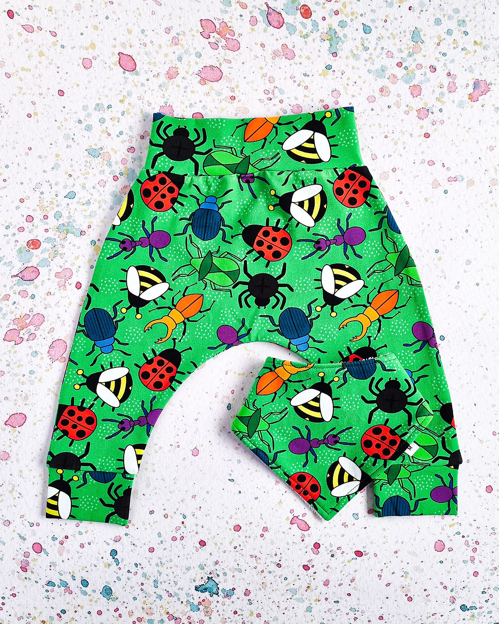 Green baby harem pants with matching bib. Colourful cartoon bugs including spiders, ants, ladybirds and bees. Simpson + C .