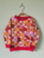 Kids' jumper with a biscuit design including Tunnocks Tea Cakes, Custard Creams, Bourbons and Party Rings