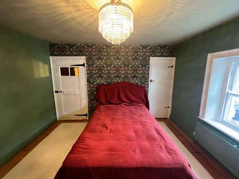 Bedroom decorating project with feature wall and painted woodwork in Haddenham, Buckinghamshire