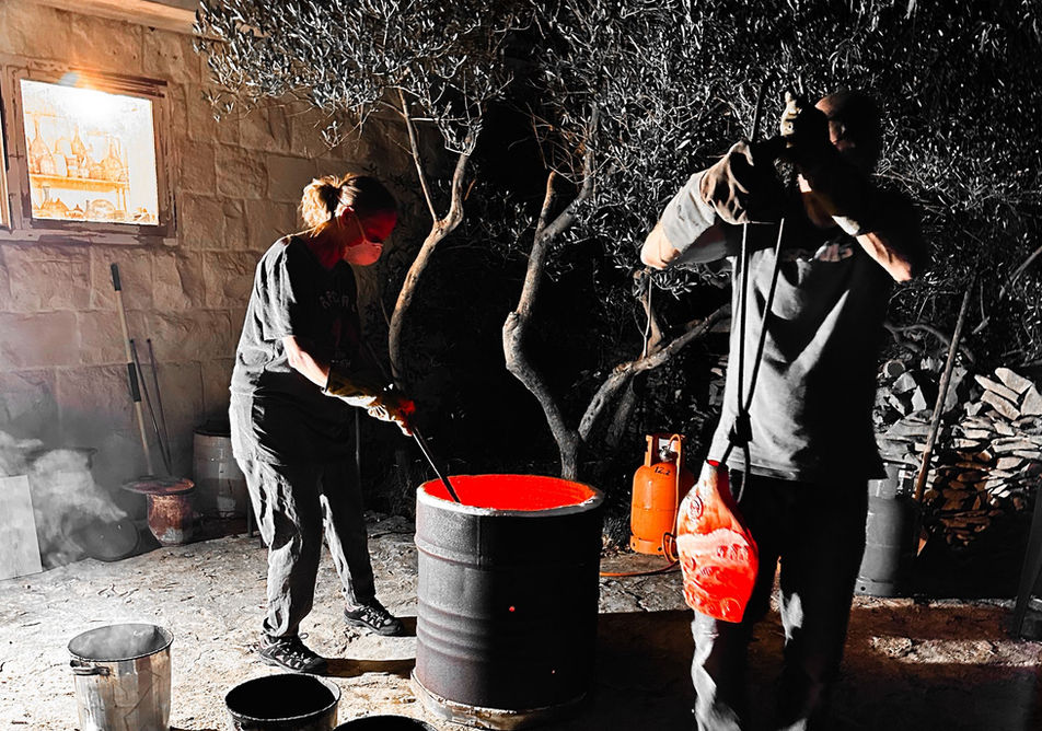 red hot pot being removed from the raku kiln