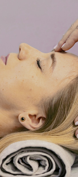 a woman getting a facial massage at a sp