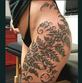 Detailed fern tattoo on hip by Garth Staunton
