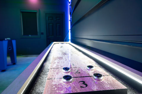 Shuffleboard table detail in game room at Cedar & Sand Beach Lake vacation rental
