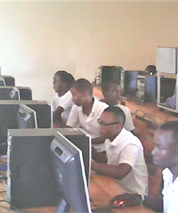 Class of older teens working hard on new computers