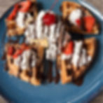 Churro waffles with vanilla ice cream and whipped cream at The Brunch Corner