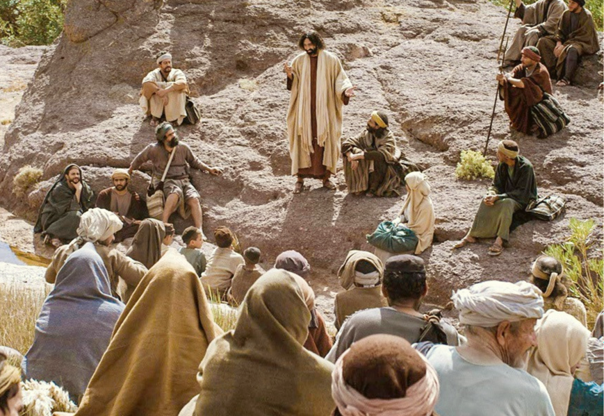Jesus teaching crowds on a hillside