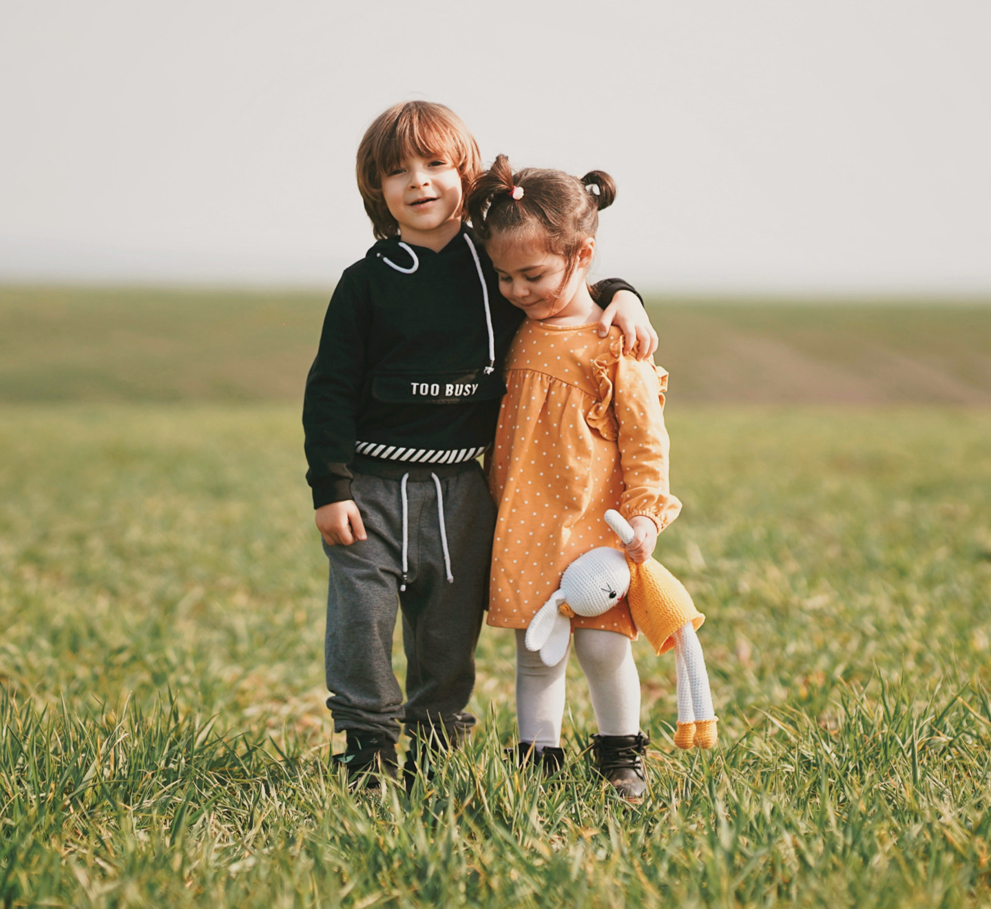 young brother and sister hugging each other