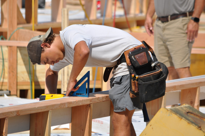 The son of the founders of Mauro Builders, continuing the family legacy by working hands-on at a construction site.