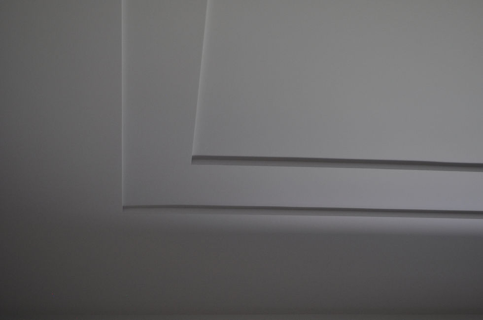 The dining room ceiling features a multi-level or 'stepped' sheetrock design, creating a layered effect.