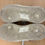 Thumbnail: Dirty soles of two white Nike Air Force 1 sneakers showing wear.