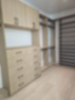 built-in walk in closet designed to organize clothing, shoes, purses and accessories