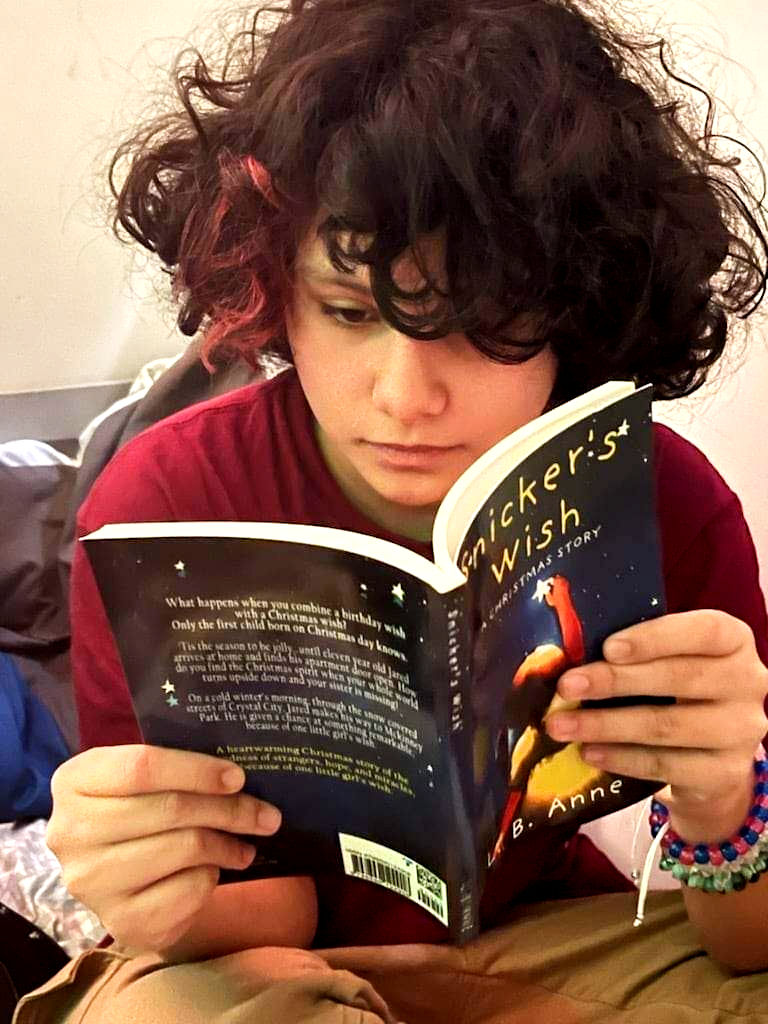 Girl reading Snicker's Wish: A Christmas Story