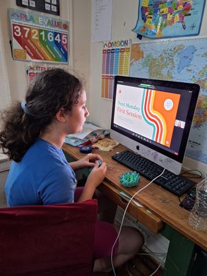 A kid from L. B. Anne's summer program watching the slideshow on her computer.