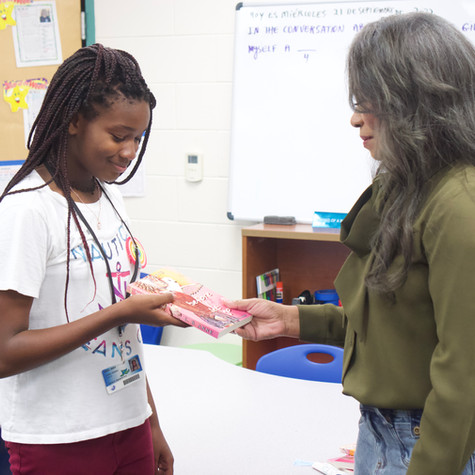 Student receiving Everfall series books.677E65FFC7FD_1_100_o.jpeg