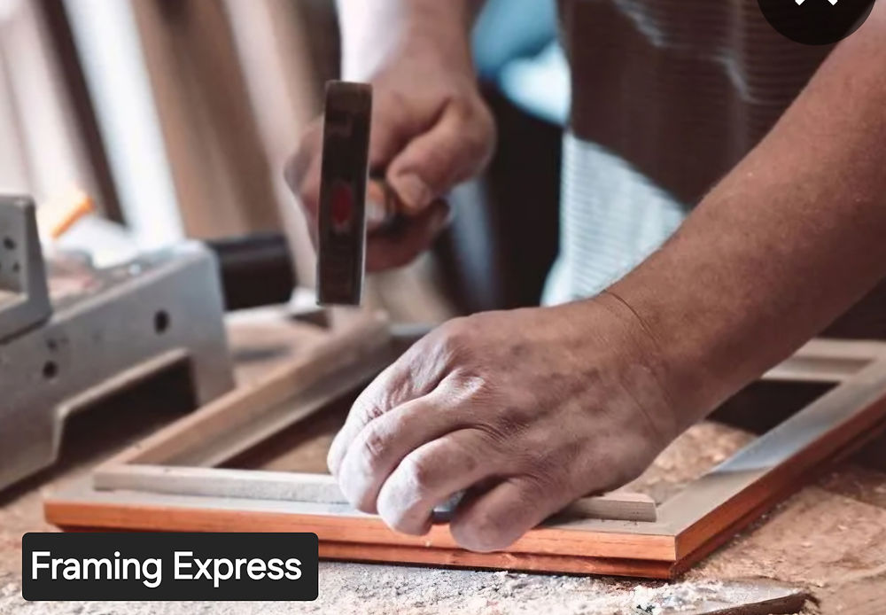 Hands hammering a picture frame, Framing Express