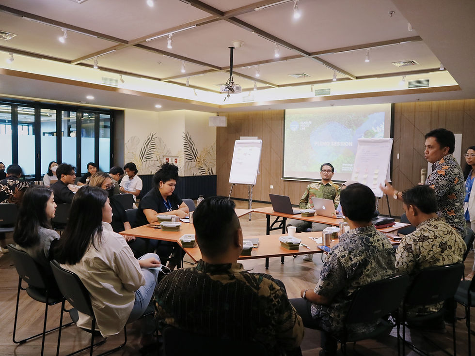 A candid shot of a presenter presenting during a discussion roundtable overlooking another roundtable discussion in CarbonEthics’ Warung Kopi Karbon (Blue Carbon Ecosystem Conservation Indonesia)