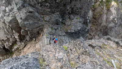 Ben arriving up the notch, the first plane part visible