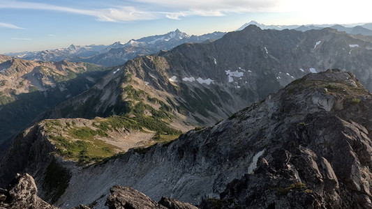 SW Middle summit looking south at Rapid Peak, backlit by Baker