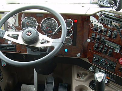 OEM truck dashboard with gauges, steering wheel, and control panels.