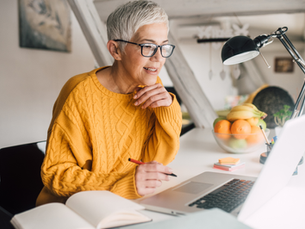 Woman researching retirement planning options on a laptop while evaluating whether a Roth conversion is the right financial decision.
