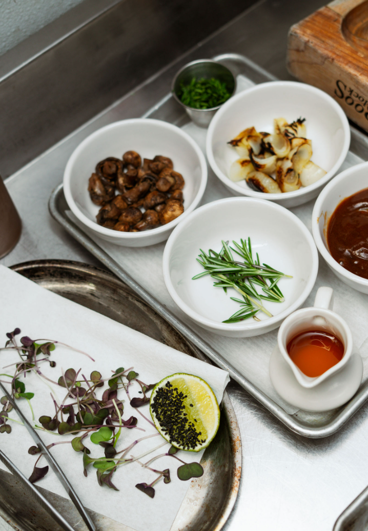 Sauces, herbs and garnishes laid out on the line