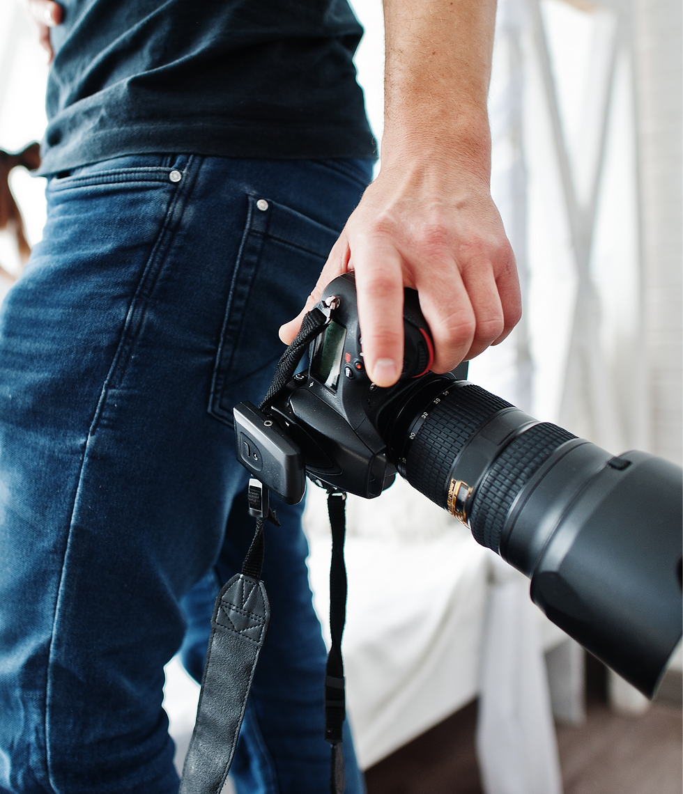 Photographer holding a professional camera, ready to capture moments. Theme 27 | Ajim