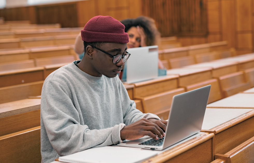 TechRoots Collective student studying on laptop in lecture hall