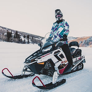 Snowmobiler looking at camera