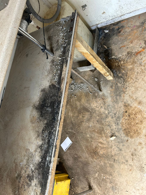 Before cleaning - dirty welfare unit floor with debris.